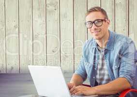 Man with laptop in wood room