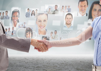 Handshake in front of sky with business people