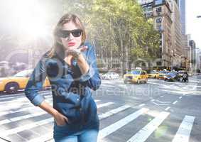 Composite image of Woman blowing kiss on street with flare