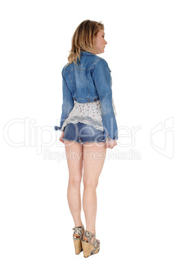 Young woman standing from back.