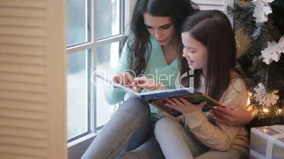 Mother and daughter reading book