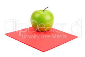 Green apple on red napkin