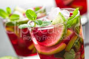 Raspberry mojito cocktail with lime, mint and ice, cold refreshing drink