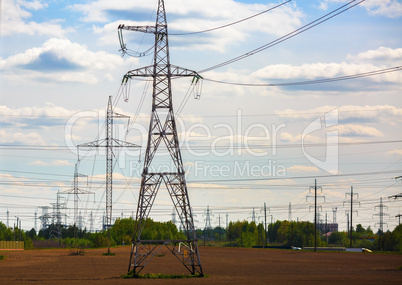 Electricity pylons through field