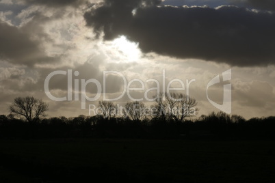 impressive clouds with the sun setting in autumn