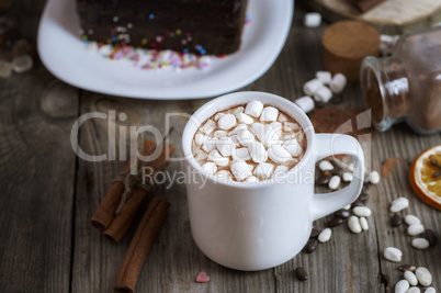 cup of chocolate drink with marshmallows into small pieces