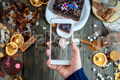 girl photographed on a smartphone table with drink hot chocolate