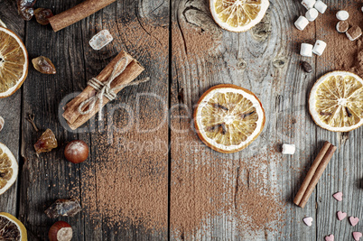 Abstract gray wooden background with spices and dried fruit
