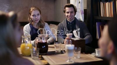 College students having coffee together in cafe