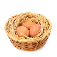 Chicken eggs in basket isolated on white background