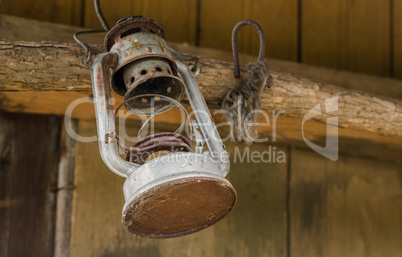 Old oil lamp on wooden wall