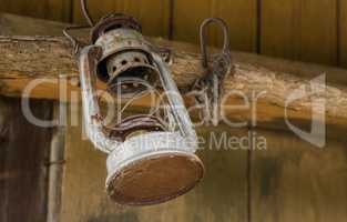 Old oil lamp on wooden wall