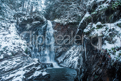 Winter waterfall in forest