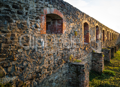 Stone castle wall with embrasure.