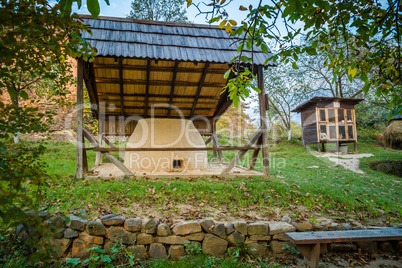 Ukrainian traditional village buildings at autumn.