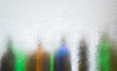 Blurred defocused bottles abstract background.