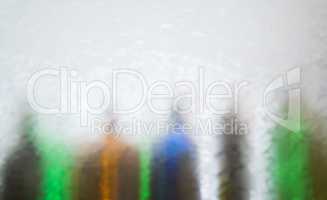 Blurred defocused bottles abstract background.