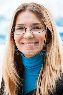 Portrait of a beautiful young woman in glasses.