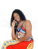 Woman sitting in colorful dress.