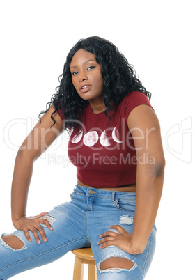 African woman sitting on chair.