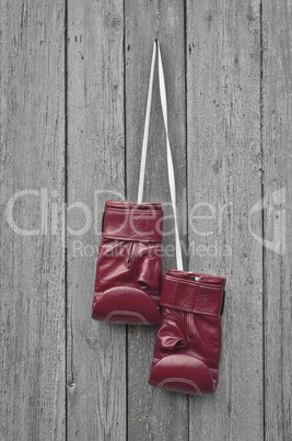 Red boxing leather gloves hangs on a nail