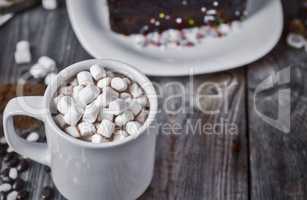 cup of chocolate with marshmallow on the gray wooden surface