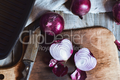 Cut in half red onion on a chopping board