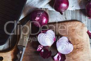 Cut in half red onion on a chopping board