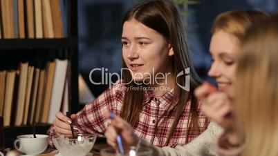 Positive teenage friends meeting at restaurant