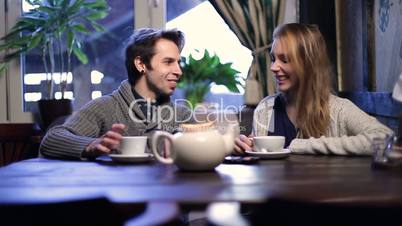 Loving couple on a date drinking tea at restaurant