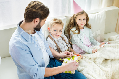 Father and children with presents
