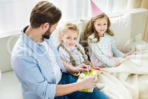 Father and children with presents