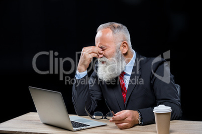 Senior  businessman with laptop