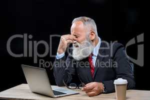 Senior  businessman with laptop