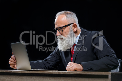 Senior businessman with laptop