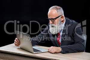 Senior businessman with laptop