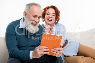 Couple using digital tablet