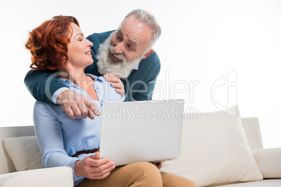 Mature couple using laptop