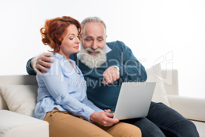 Mature couple using laptop