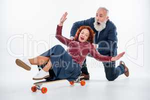 Mature couple with skateboard