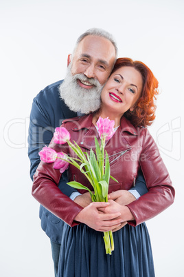 Man presenting flowers to woman