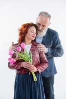 Man presenting flowers to woman