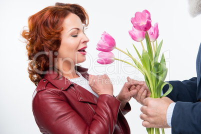 Man presenting flowers to woman