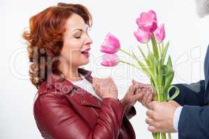 Man presenting flowers to woman