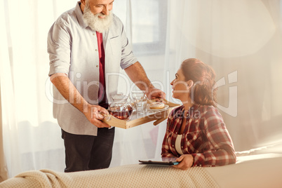 Man holding tray with tea