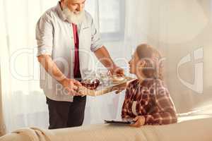 Man holding tray with tea