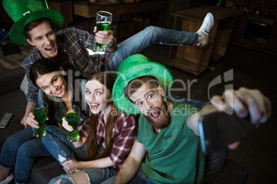 high angle view of friends with beer making selfie on St.Patrick's day