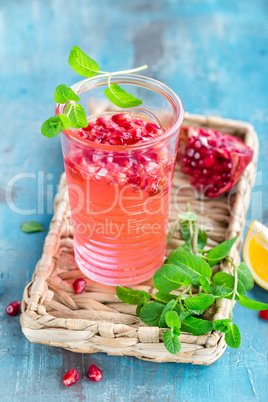 Infused pomegranate water with fresh lemon and ice, cold healthy refreshing and detox drink