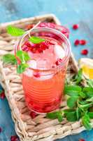 Infused pomegranate water with fresh lemon and ice, cold healthy refreshing and detox drink