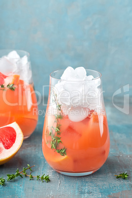 Grapefruit and thyme gin cocktail, refreshing drink with ice